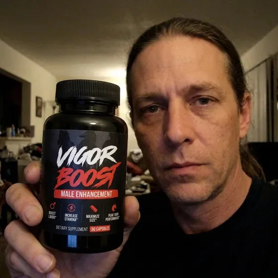 A VigorBoost&reg; customer holding the bottle